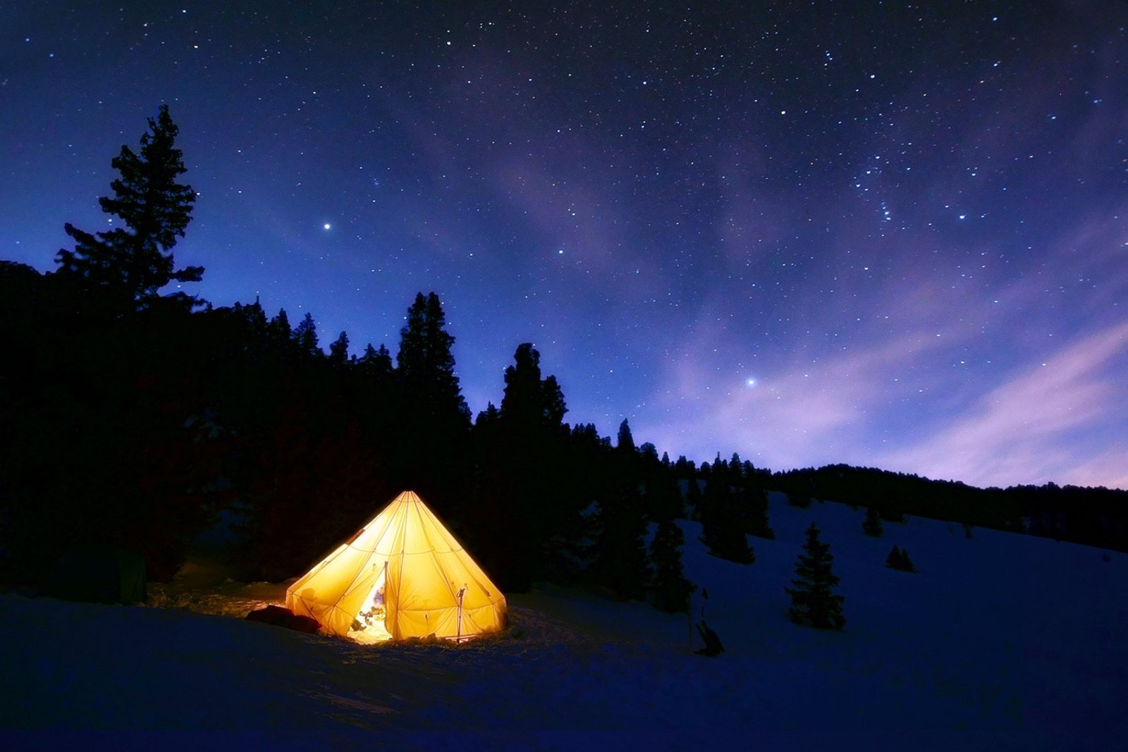 Tipi éclairé sous un ciel étoilé dans le Vercors
